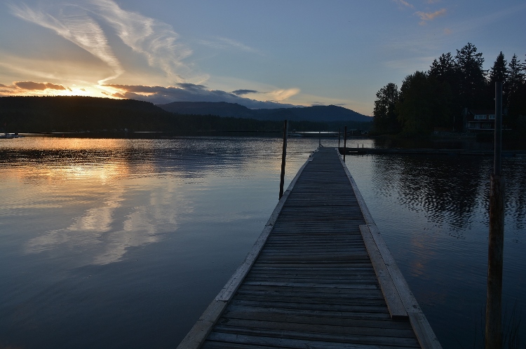sunset over lake with pier